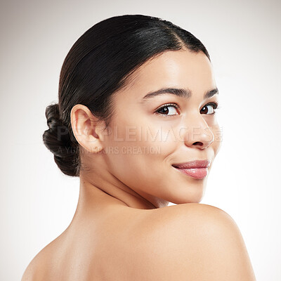 Buy stock photo Face of a young beautiful mixed race woman smiling and posing against a grey studio background. Confident hispanic female posing against a background