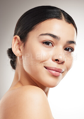 Buy stock photo Face of a happy young beautiful mixed race woman smiling and posing against a grey studio background. Confident hispanic female posing against a background