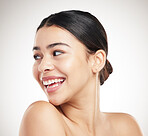 Young cheerful beautiful mixed race woman posing against a grey studio background. Confident hispanic female posing against a background