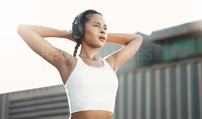 Buy stock photo Stretching, outdoor and woman with headphones, exercise or streaming music with podcast, relax or stress relief. Female person, athlete or runner with headset, radio or wellness with training or rest