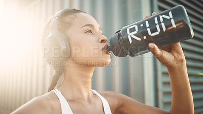 Buy stock photo Headphones, runner or girl drinking water in city to hydrate, relax or healthy energy on exercise break. Tired, thirsty or fit athlete woman with liquid for hydration in fitness training or workout 
