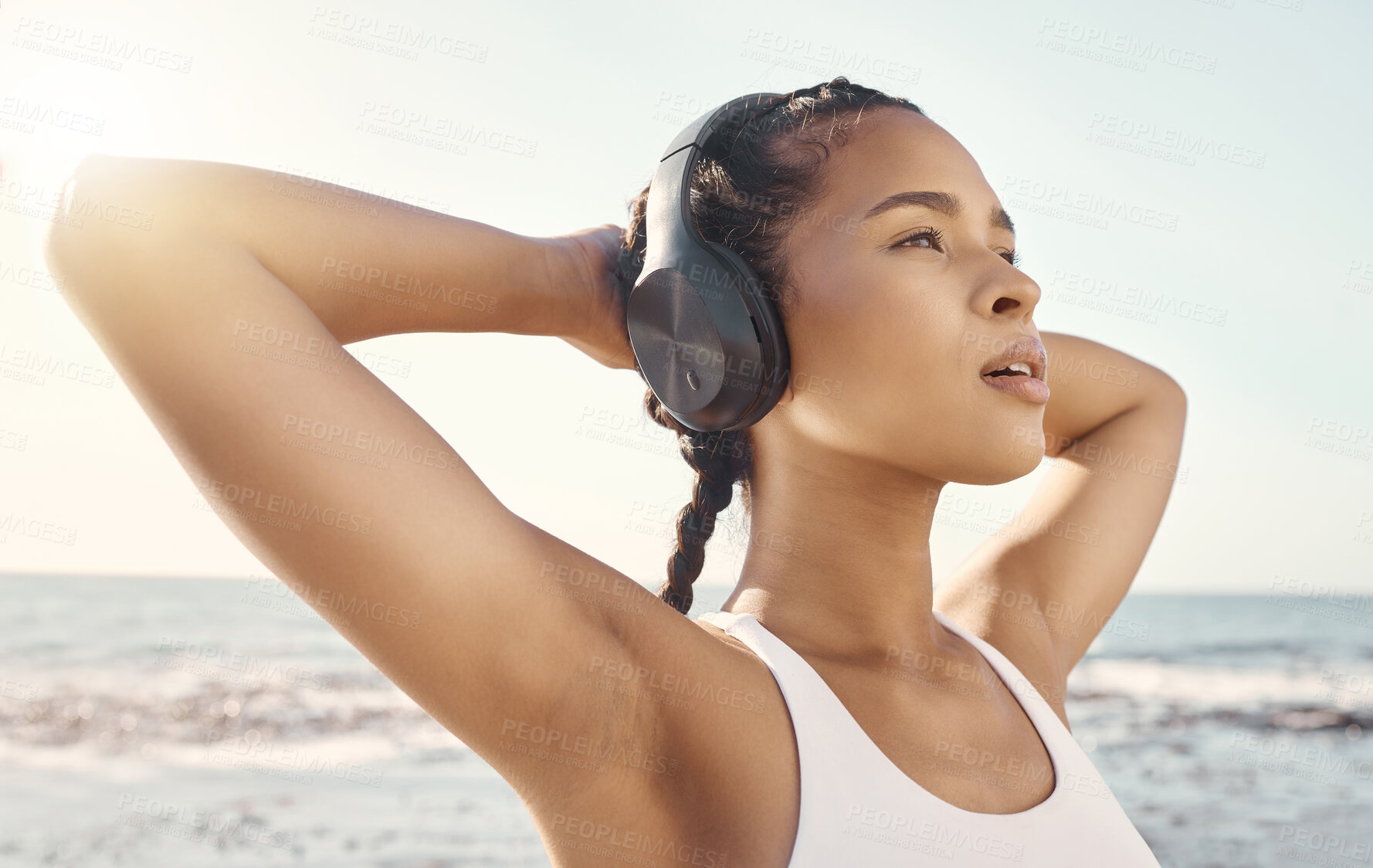 Buy stock photo Stretching, headphones and woman at beach fitness, exercise or running mindset, thinking and inspiration music. Health, podcast and athlete, runner or sports person by ocean listen or audio streaming