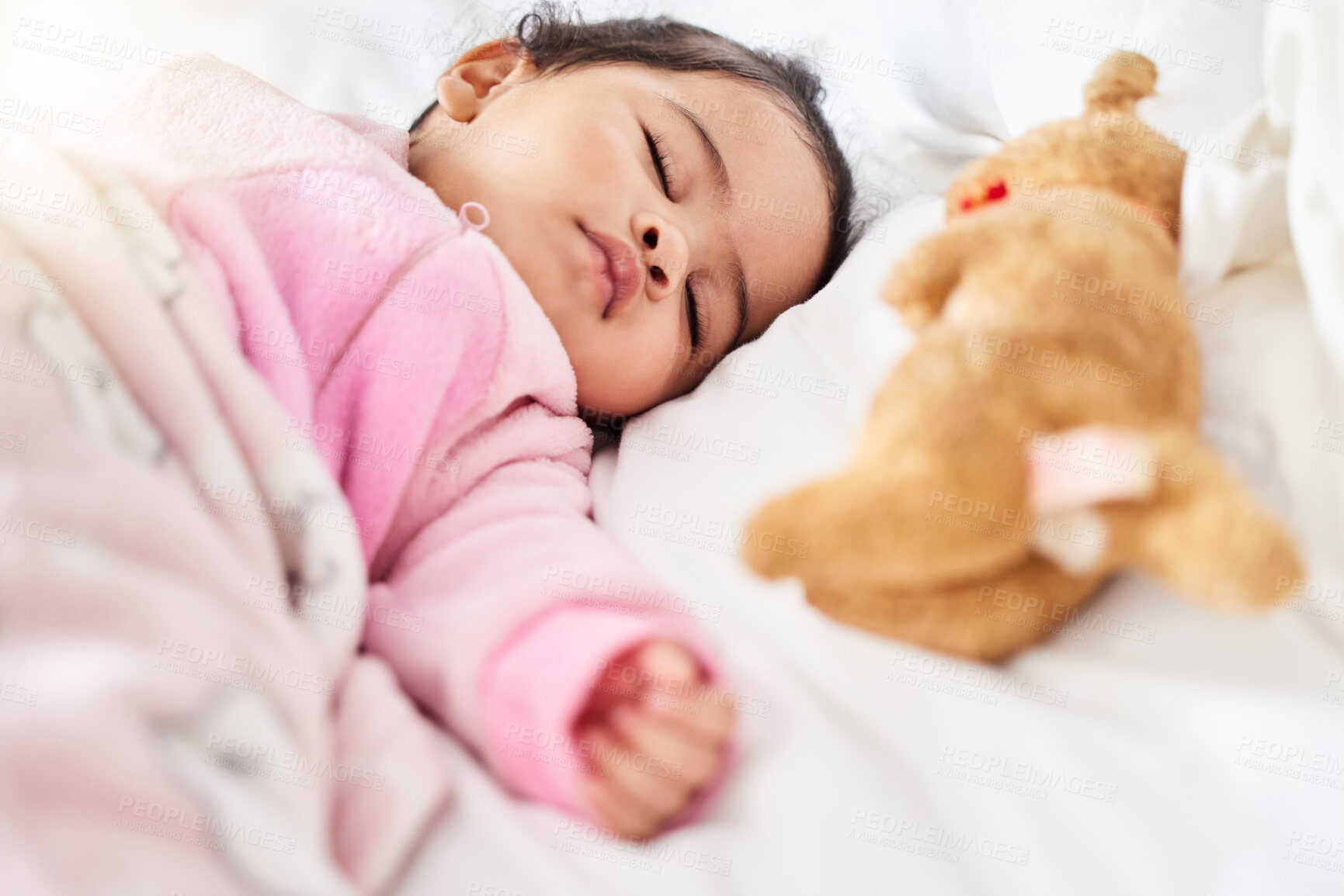 Buy stock photo Baby, girl and sleeping in bed with teddy bear, animal and peace in home with blanket and comfort. Child, rest and sleep in morning, nap and routine for health, wellness and calm face of infant