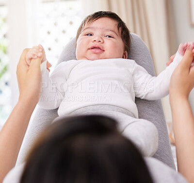 Buy stock photo Mother, baby and bedroom with love and care or security holding hands for bond or comfort and peace. A woman or mom and infant child on legs for safety in a family home with growth and connection