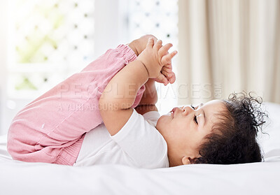 Buy stock photo Baby, feet and hands with curiosity in bedroom for motor skills, growth or development. Little girl, toddler and grab of toes, looking and playing with excitement, discovery and milestone in home