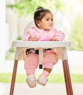 Buy stock photo Baby, girl and sitting in feeding chair with thinking, curious and calm expression in home or apartment. Child, kid and relax with comfort, peace and security for development or hungry in house