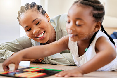 Buy stock photo Education, smile and black woman playing with child on the floor in the living room at modern home. Abacus, mathematics and young African mother helping girl kid with counting at house together.