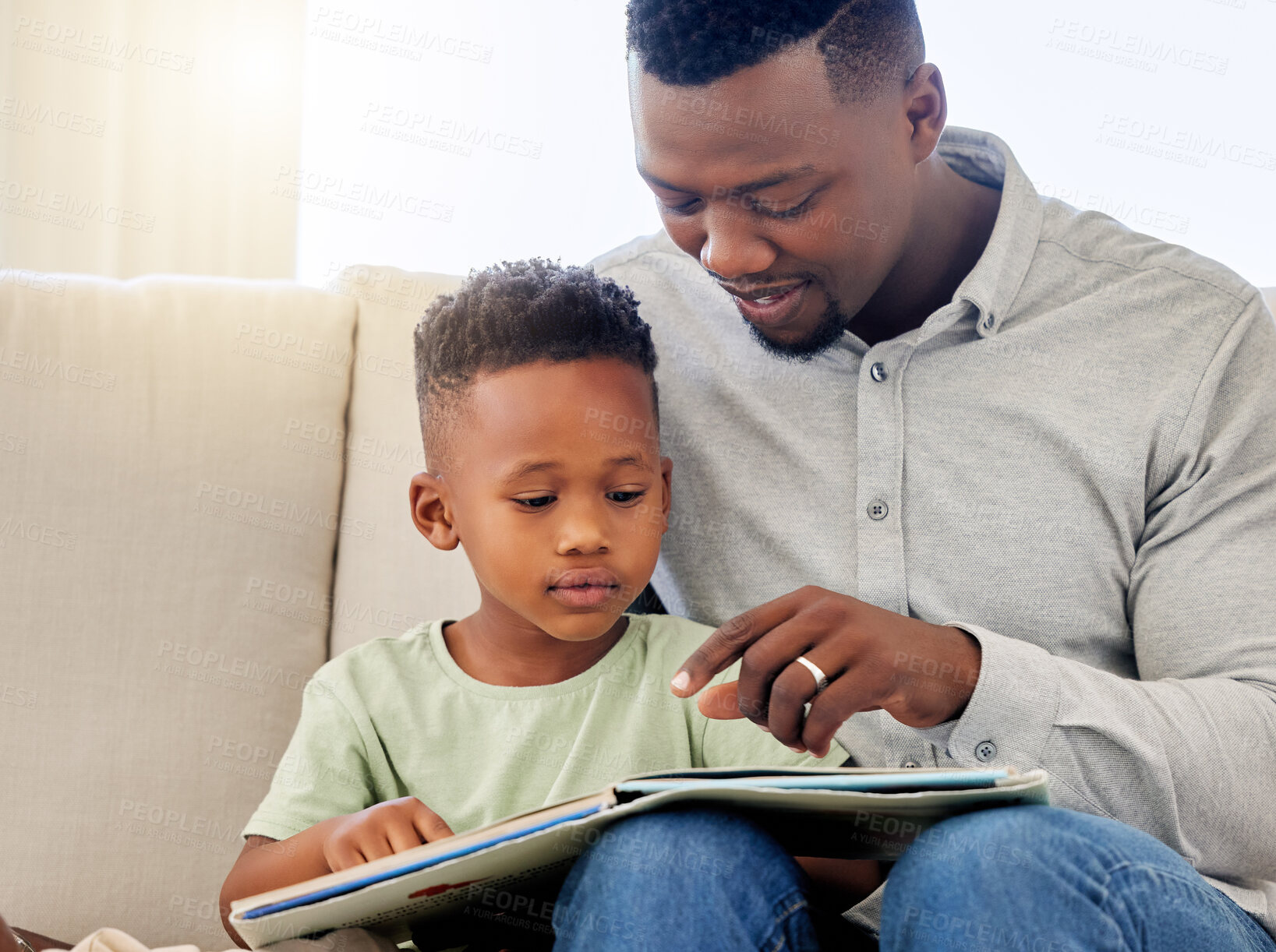 Buy stock photo African, father and child in home reading book on sofa with development of education, learning and knowledge. Happy dad, teaching and show kid a story in books and relax in living room on couch