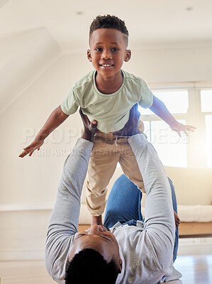 Buy stock photo Airplane, happy and portrait of child with father in the living room of modern house having fun. Smile, love and young African boy kid playing with his dad on the floor of the lounge at home together
