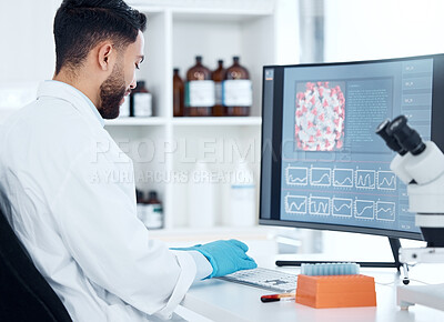 Buy stock photo One mixed race scientist from the back analysing medical test samples and data from microbiology and genetic research on computer screen in lab. Young man developing cure for virus with biotechnology