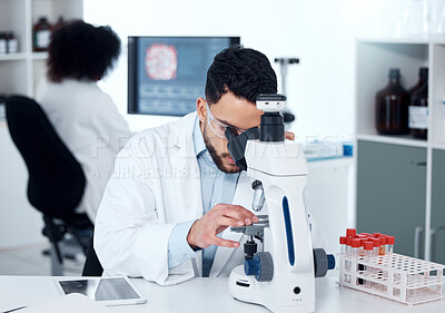 Buy stock photo Science, particles and scientist analyzing with a microscope in a medical laboratory with concentration. Biotechnology, pharmaceutical and male researcher working on scientific project for healthcare