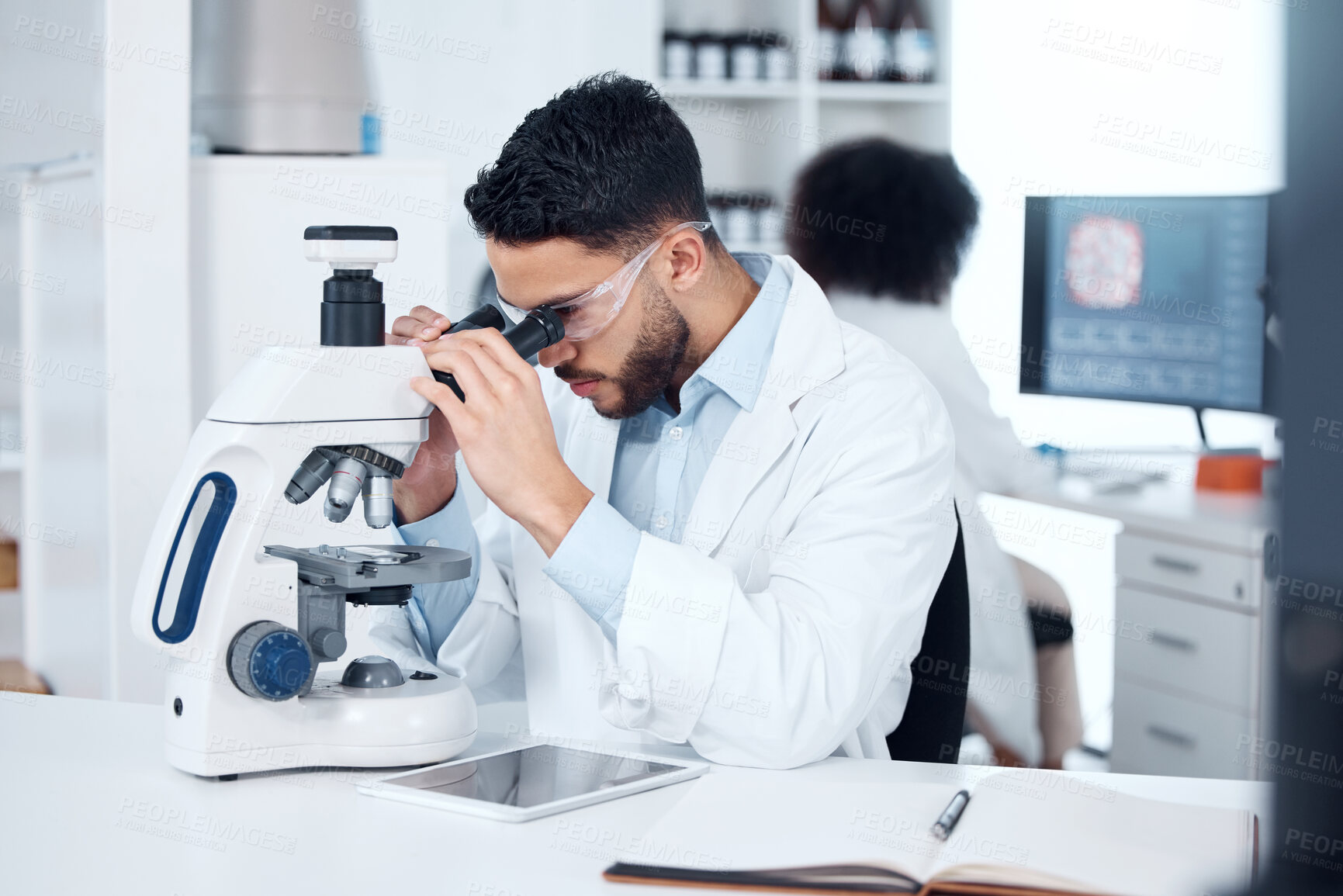 Buy stock photo Science, microscope and male scientist analyzing with biotechnology in a medical laboratory. Particles, pharmaceutical and man researcher working on scientific project for healthcare innovation.