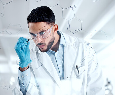 Buy stock photo Young focused hispanic chemist drawing a dna structure on a board while brainstorming. Serious scientist planning his research experiment in the lab, wearing safety goggles. Young man in a lab