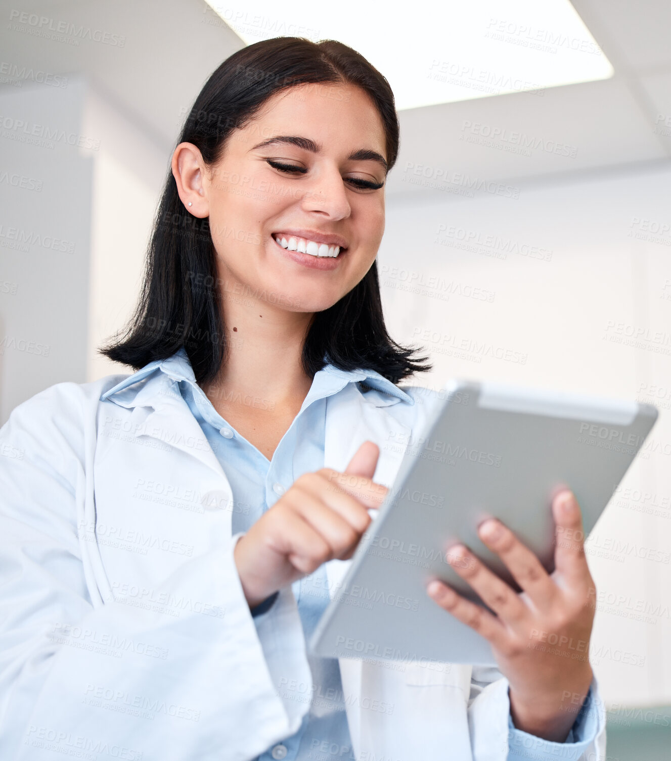 Buy stock photo Smile, tablet and young woman doctor with confidence in her office doing research at clinic. Happy, medical and professional female healthcare worker from Canada with digital technology in hospital.