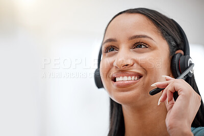 One young hispanic happy and cheerful female call center agent wearing a headset and working in customer service at work. Face of a hispanic woman answering calls working at a call center