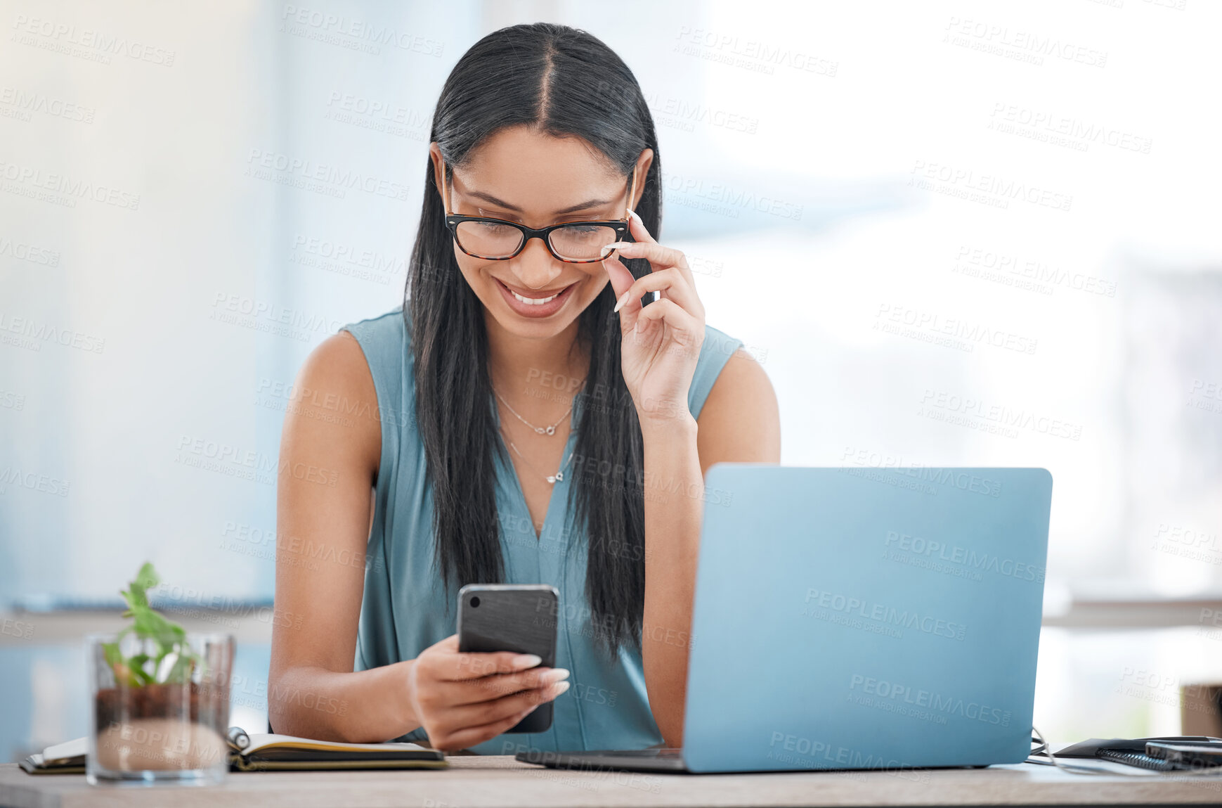 Buy stock photo Happy business woman, laptop and phone for communication, networking or social media at office. Female person or employee smile on mobile smartphone in online chatting, texting or search at workplace