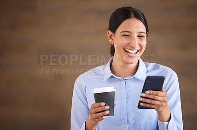 Smiling mixed race businesswoman isolated against a brown background with copyspace and using a cellphone to browse the internet during a coffee break. Hispanic professional laughing at social media