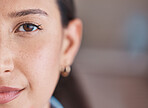 Closeup portrait of face and brown eye. Focused hispanic business woman standing in her office. Powerful, leading single female only in her workplace. Face of a beautiful woman