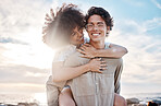 Portrait of a young  mixed race couple enjoying a day at the beach looking happy and in love