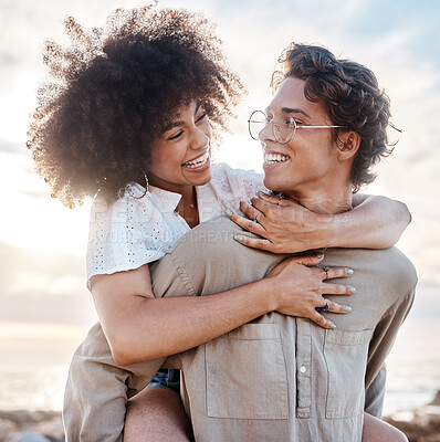 Buy stock photo A young  mixed race couple enjoying a day at the beach looking happy and in love