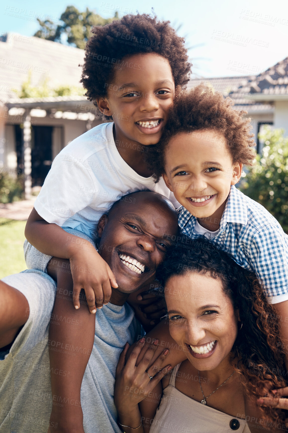 Buy stock photo Happy african american family of four having fun while taking selfies in the sun. Carefree parents carrying sons for piggyback rides while bonding outside. Mom and dad enjoying quality time with kids