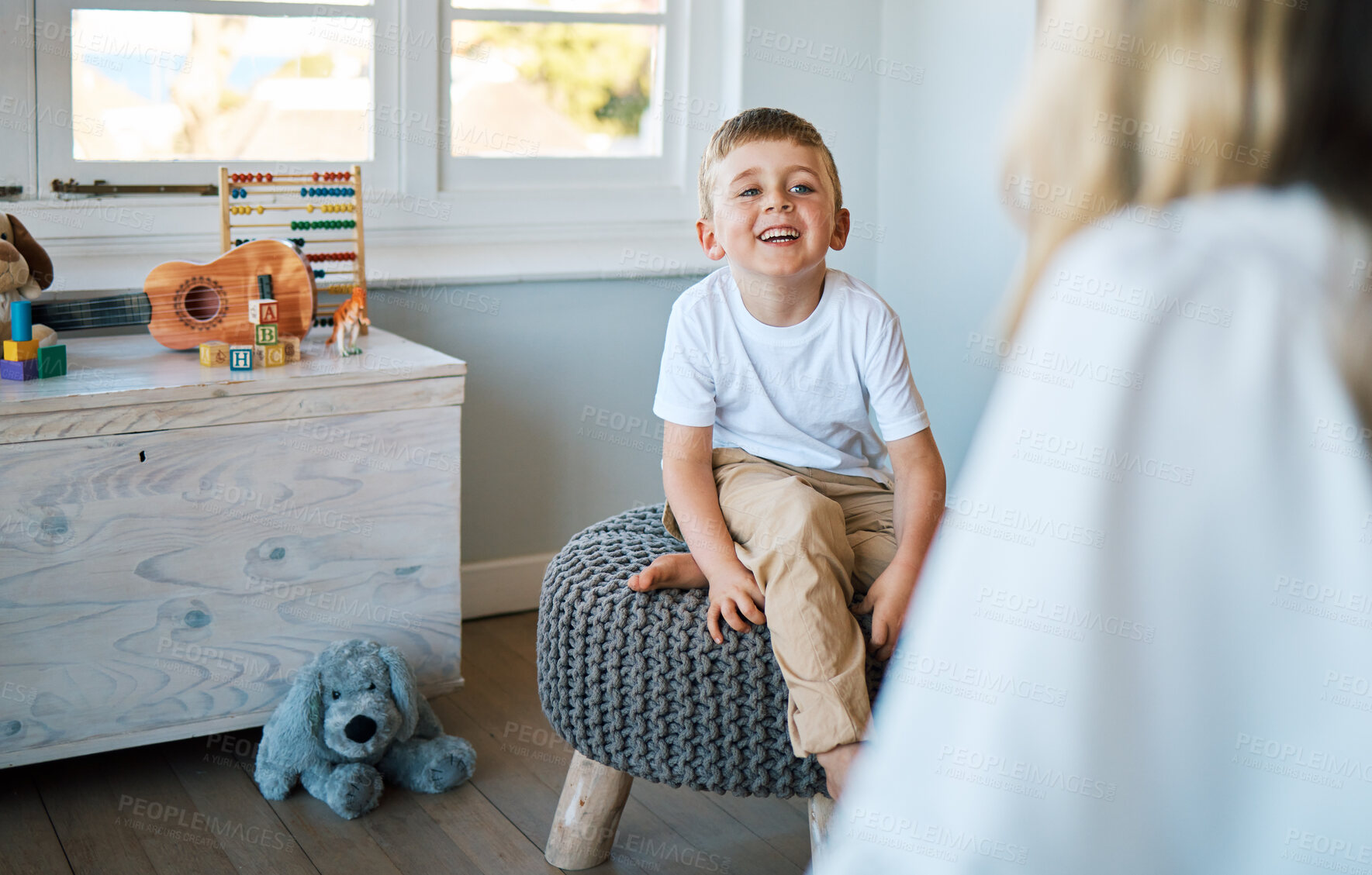 Buy stock photo Therapist, psychology and boy on a chair, talking and child development with a smile, foster home and adoption. Male kid, young person or counsellor in an office, speaking and consultation for growth