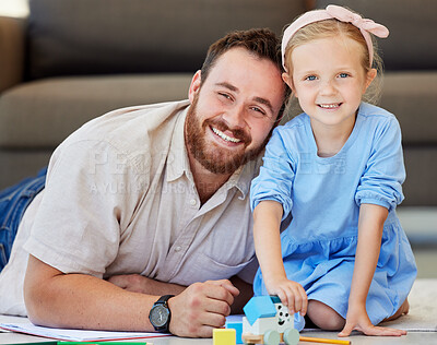 Buy stock photo Portrait of father and daughter bonding at home. Dad watching daughter play with toys. Parent and child smiling happy to be together