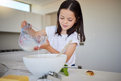 Buy stock photo Happy little girl baking at home. Smart girl mixing ingredients to prepare dough in the kitchen. Helpful child in the kitchen