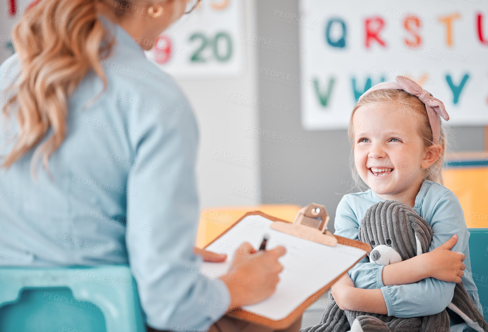 Buy stock photo Girl child, psychologist and writing with clipboard, smile and listening for support, help and school counseling program. Woman, female kid and conversation for mental health, psychology and wellness