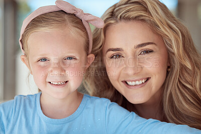 Buy stock photo Adorable little girl smiling for selfies while bonding with her mother at home. Caring and loving mother relaxing with her cute daughter. Single parent spending quality time with child