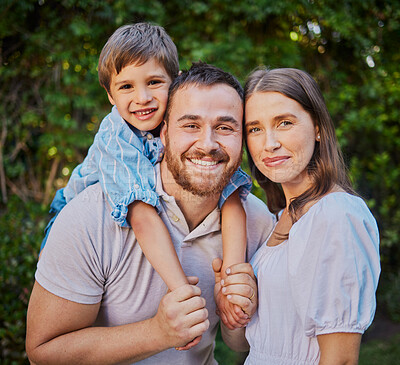 Buy stock photo Happy family in the garden at home. Caucasian family of three standing together outside in the yard. Handsome man, beautiful woman and cute son spending quality time together and bonding outside