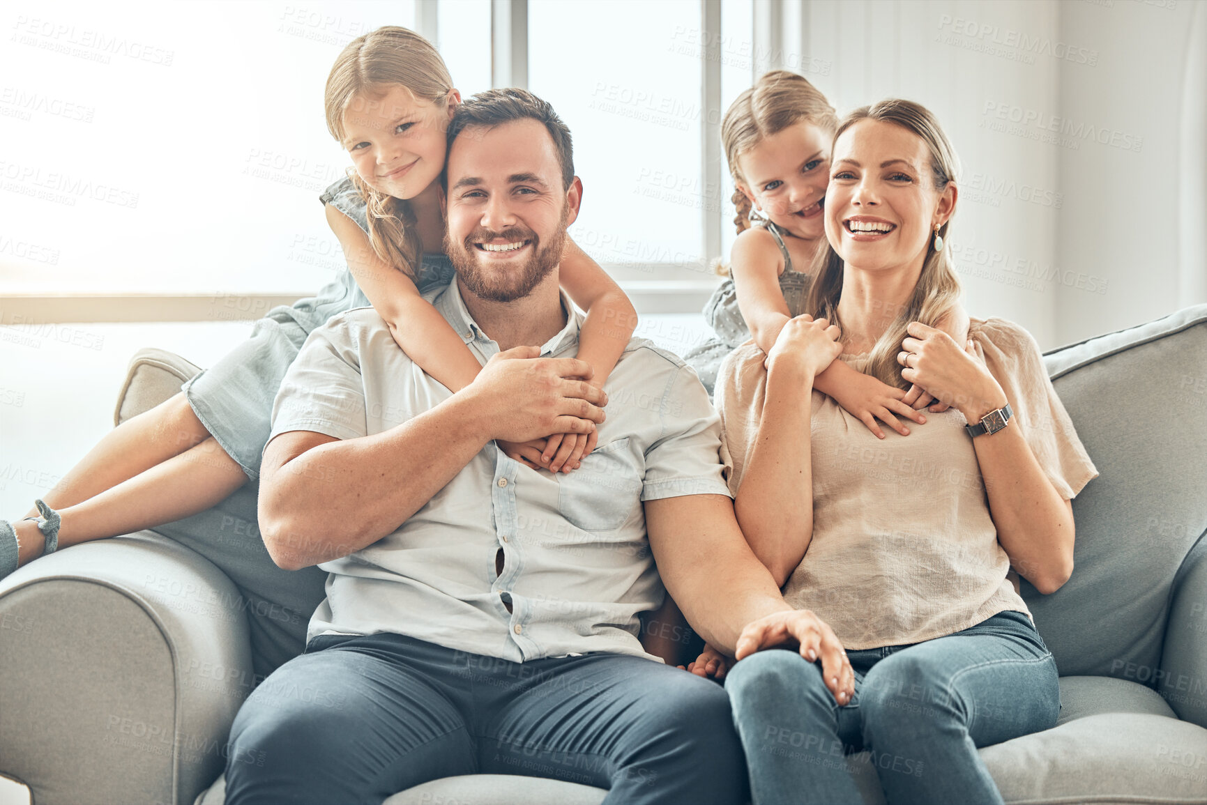 Buy stock photo Portrait of mom, dad and children on sofa in living room for bonding, quality time and relax together. Happy family, smile and parents hugging girls for care, love and support at home on weekend