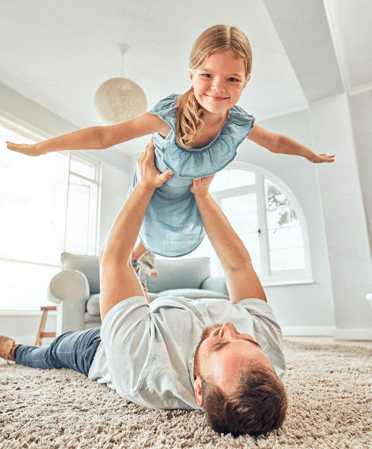 Buy stock photo Portrait, dad and child in home for flying game, bonding and playful girl in living room for happy family. Happiness, father and daughter play airplane on floor with smile, support and love in house