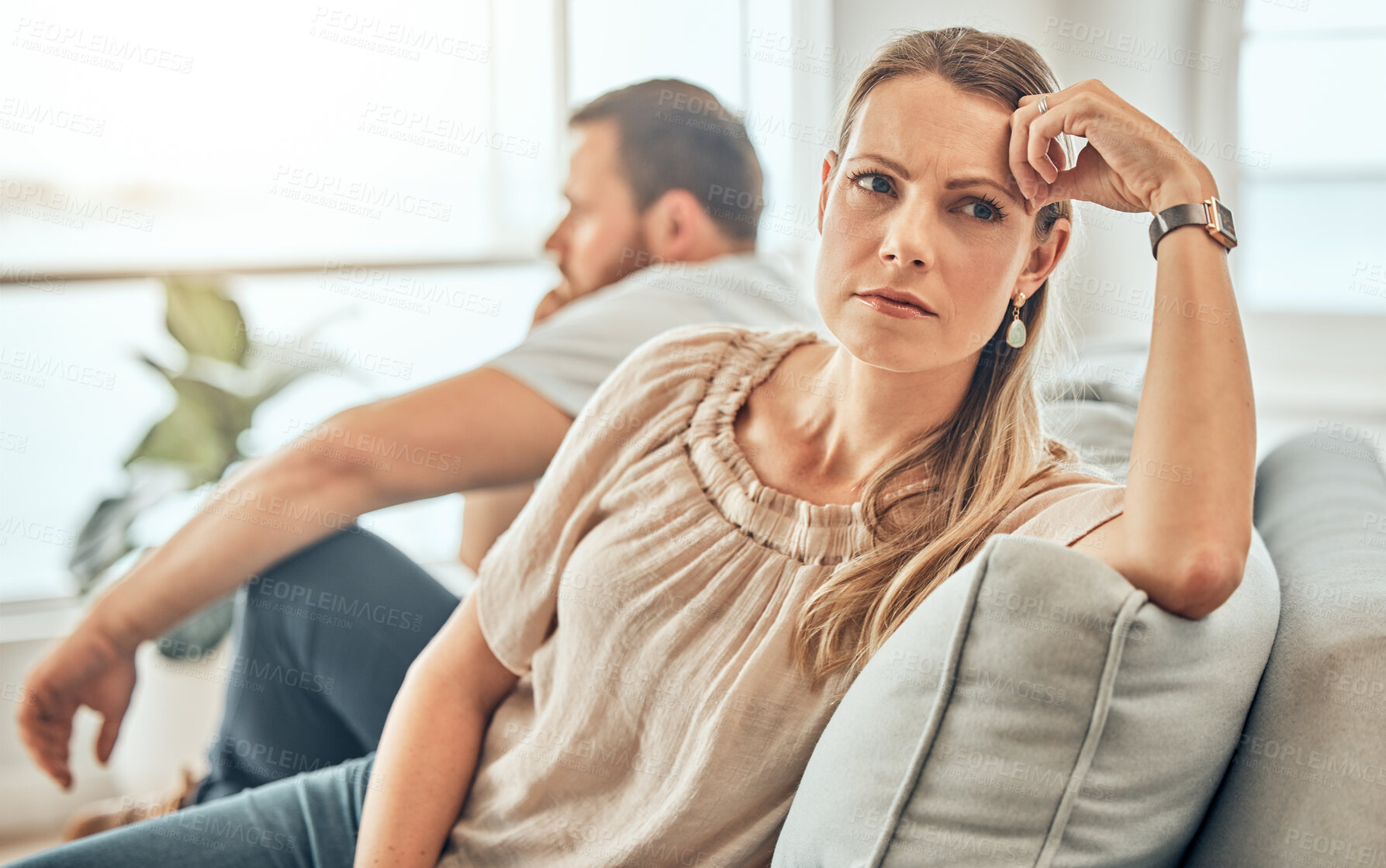 Buy stock photo One young woman feeling frustrated and annoyed after an argument with her husband. A wife feeling distant after fighting due to marriage problems. A negative situation that could end up in divorce
