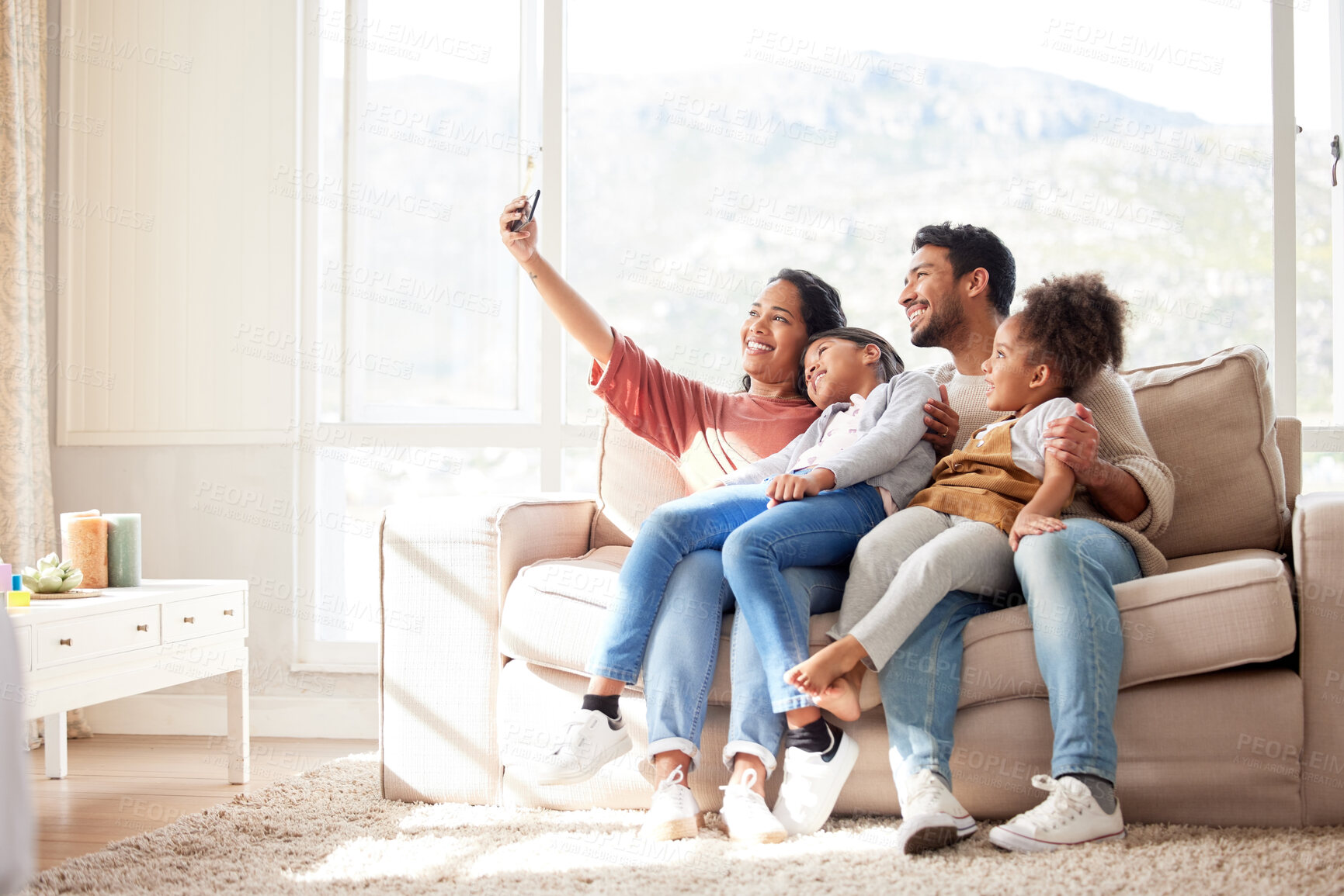 Buy stock photo Parents, children and sofa selfie with smile, happiness and bond in lounge for social media app. Father, mother and daughters with care, love and together for profile picture, blog and happy on couch