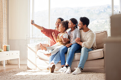 Buy stock photo Parents, children and couch selfie with smile, happiness and bond in lounge for social media app. Father, mother and daughters with care, love and together for profile picture, blog and happy on sofa