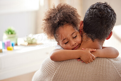 Buy stock photo Adorable little mixed race girl with curly afro hair hugging her father at home. Hispanic father bonding and embracing his daughter lovingly. Cheerful african american child with her single parent