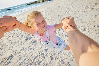 Buy stock photo Father spinning daughter, having fun on the beach. A cute smiling little girl playing with her parent on vacation. Fun family vacation
