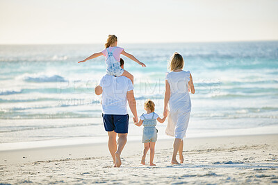 Buy stock photo Happy family walking  the beach. Rear view of young parents with children having fun on vacation. Little boy and girl enjoying summer with mother and father