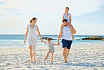 Happy family walking  the beach. Smiling young parents with children having fun on vacation. Little boy and girl enjoying summer with mother and father