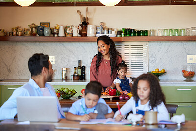 Buy stock photo Happy mixed race mother cooking in the kitchen for her family. Dad working from home with laptop while kids do homework or being homeschooled. Family of five at home during coronavirus pandemic 