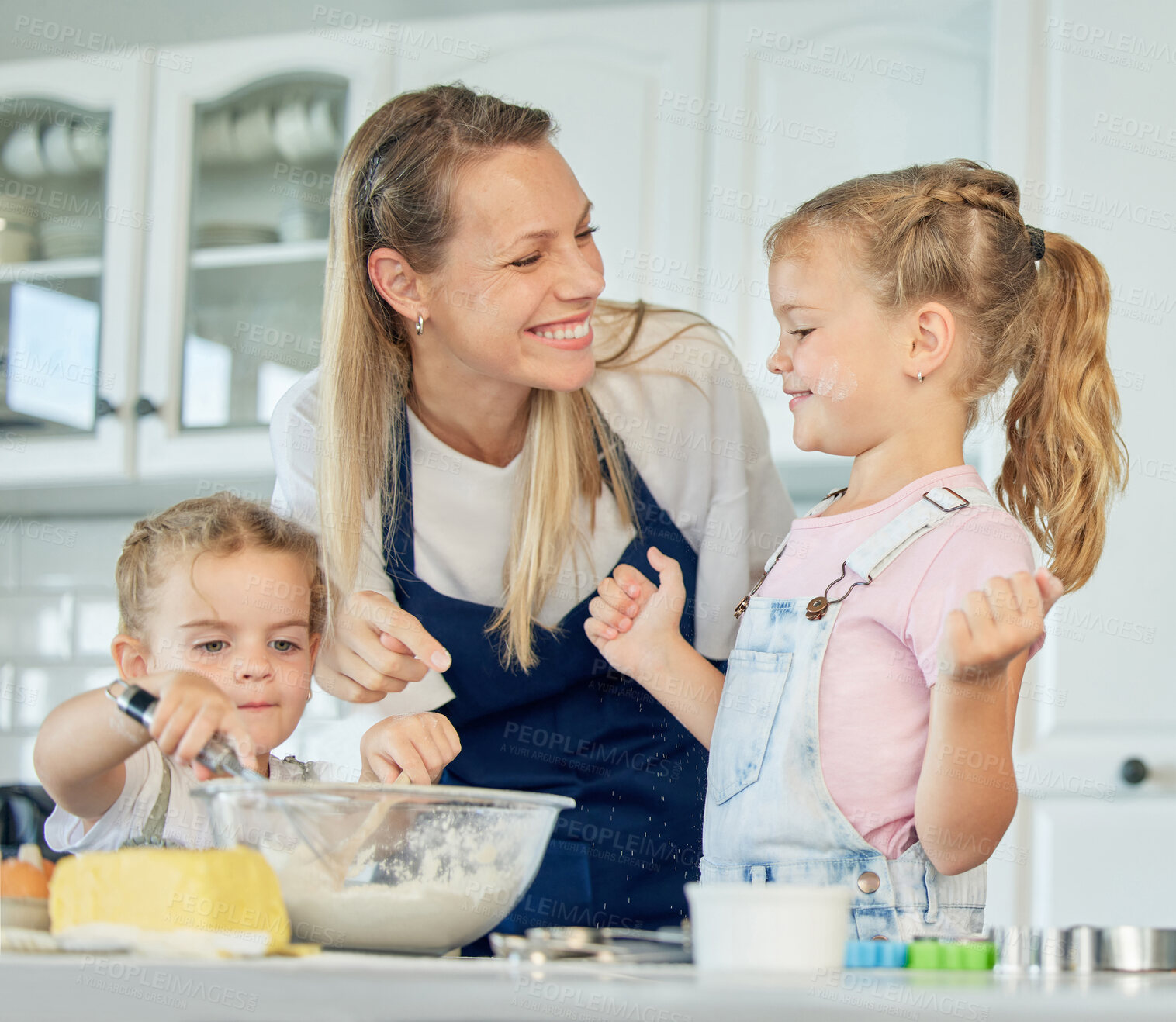 Buy stock photo Happy loving family are baking together. Mother and two daughters are cooking cookies and having fun in the kitchen. Homemade food and little helper.