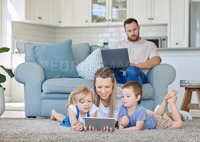 Mother and two kids watching something on digital tablet. Little girl and boy watching educational cartoon videos or on video call with tablet. Dad works from home