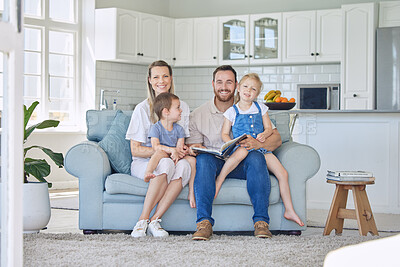 Portrait of young parents with children reading a book, caucasian family of four smiling and enjoying a story. Cheerful couple teaching their two children how to read while sitting on a sofa
