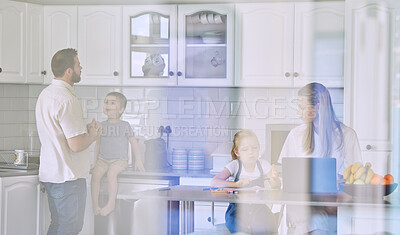 Buy stock photo Happy young caucasian family having lunch time with fresh fruit in a bright kitchen. Affectionate father kissing his wife while she's using a laptop and sitting with her kids at home