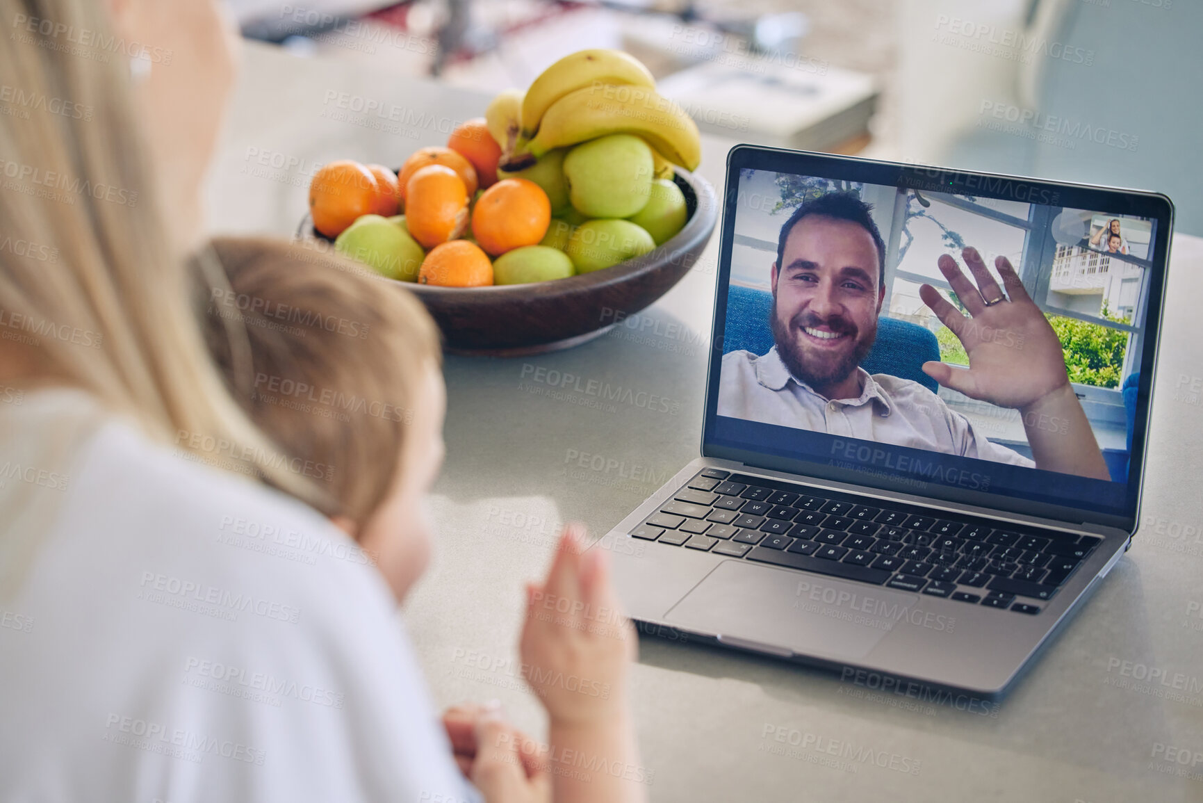Buy stock photo Mother and son talking to husband through video call on a laptop at home. Long distance caucasian father waving to his son during a video conference call. Young family communicating through technology