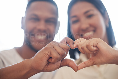 Closeup of happy mixed race couple forming heart shape with hands. Two lovers showing heart sign by hands together. Shape of love
