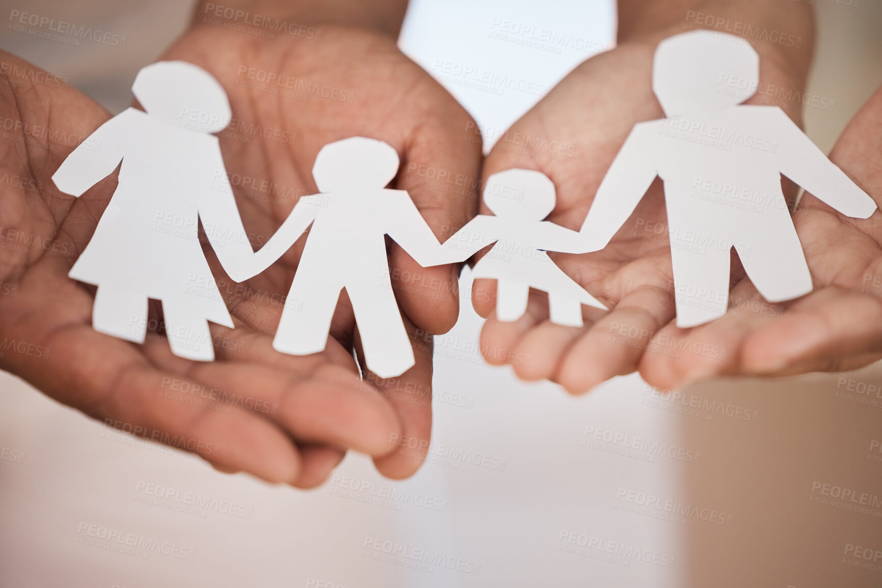 Buy stock photo Closeup of a couples hands holding paper cutout of a perfect family. Symbol of home cover, insurance, health, adoption, custody, law, safety, security protection, foster, adoption family home concept 