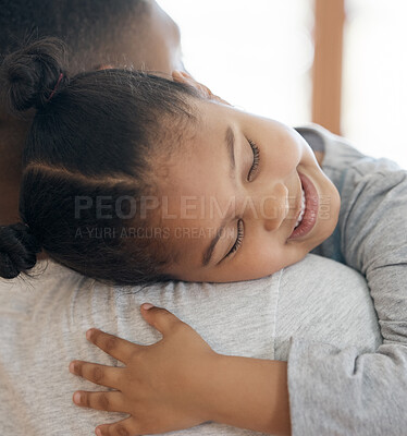 Buy stock photo Closeup adorable little girl smiling and hugging her single father inside at home. Cute mixed race child enjoying weekend free time with single parent. Hispanic man bonding and holding his daughter