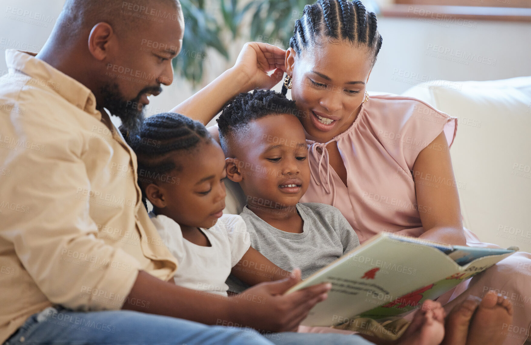 Buy stock photo Family, together and reading on couch for fantasy, relax and smile for storytelling in living room. African man, mother and children on sofa for bond, happiness and home school or education or study 